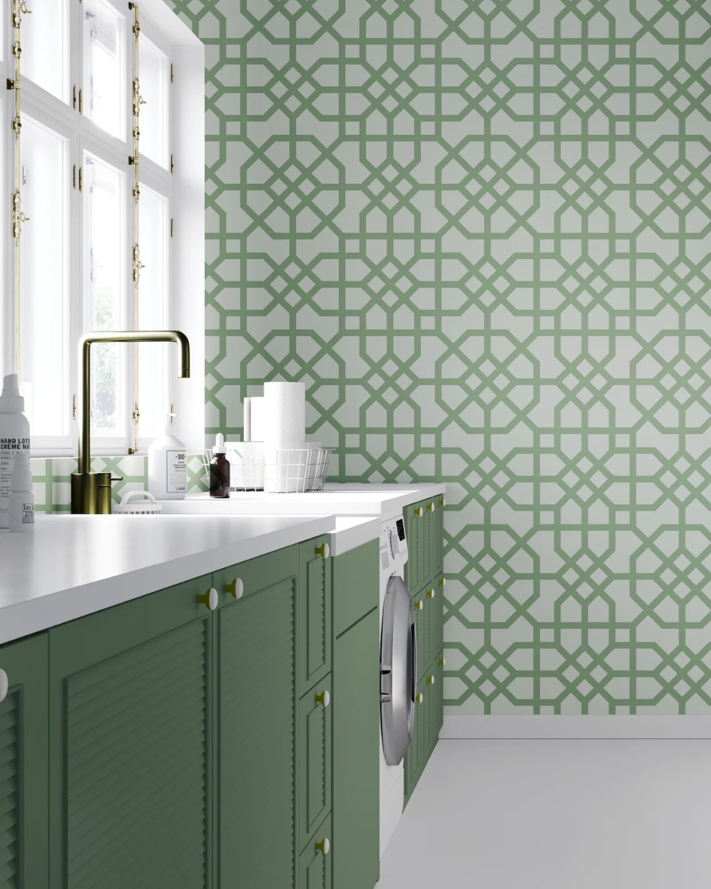 A modern laundry room corner featuring mint green cabinets, a white countertop with a brass faucet, and a white washing machine. The wall is decorated with a mint green geometric Athens pattern on a white background.