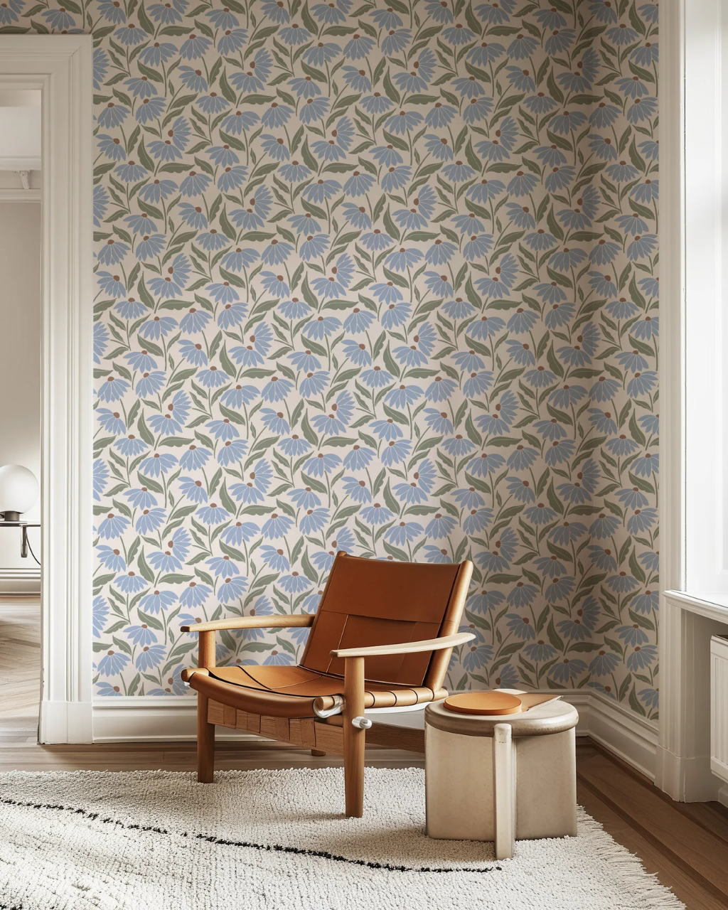 Daisy Patch wallpaper with blooming blue daisies, green stems and warm off-white background, creating a dreamy, cheerful pattern in a styled room interior | Funky Paper Co