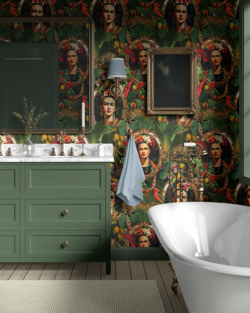 A styled bathroom interior featuring a green vanity with a white marble sink, a freestanding white bathtub, and walls covered in dark green Lush Tropical wallpaper with repeated portrait illustrations and ornate gold-framed wall art.