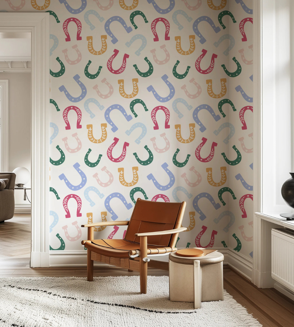 Horseshoe pattern wallpaper with multicolor horseshoes on an off-white background for a playful western nursery.