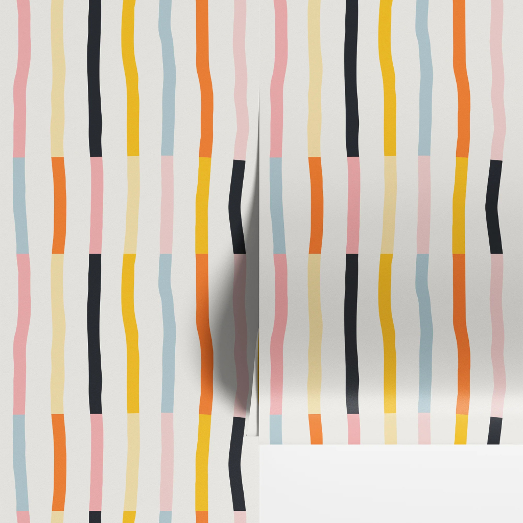 Rainbow geo stripe nursery wallpaper with hand-drawn vertical stripes in blue, pink, yellow, orange, and black on off-white.