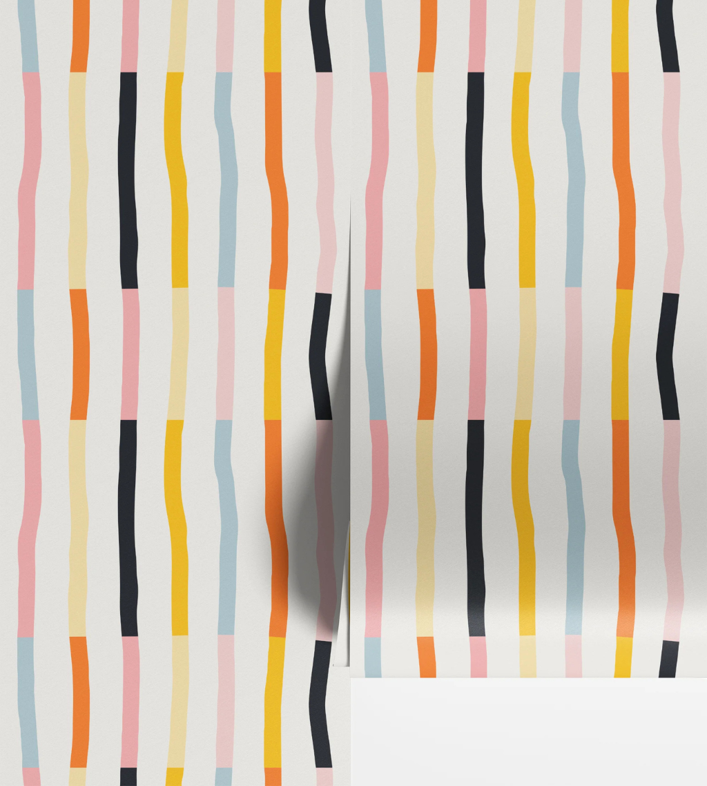 Rainbow geo stripe nursery wallpaper with hand-drawn vertical stripes in blue, pink, yellow, orange, and black on off-white.