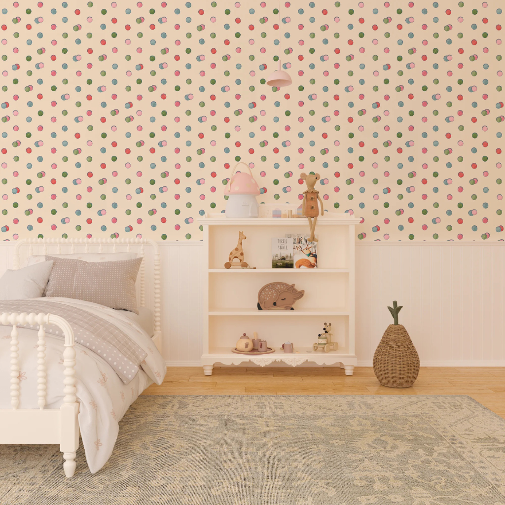 Child's bedroom with retro macaroons wallpaper with a green, blue, pink, and red polka dot pattern on a cream background.