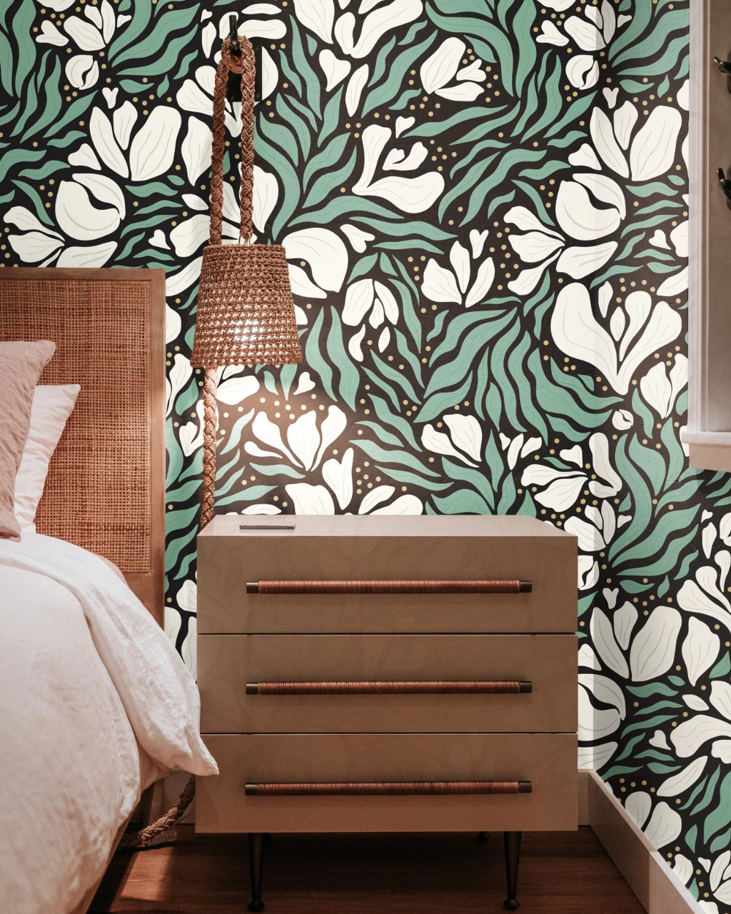Bedroom interior with Untamed Garden wallpaper by Clearly Tangled Studio, showing white lily petals and green leaves on a black backdrop. | Peel and stick wallpaper by Funky Paper Co